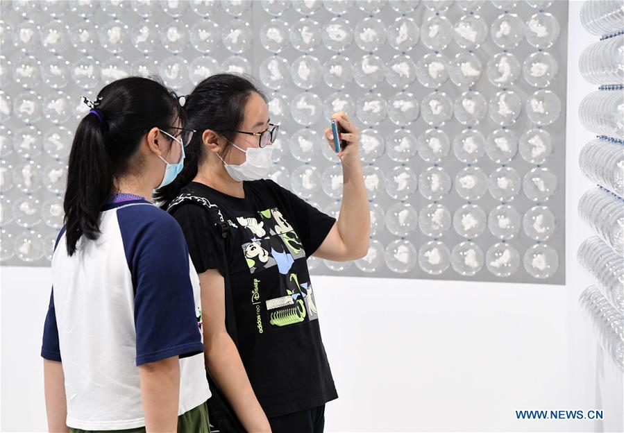 Visitors view contemporary art exhibition at Times Art Museum in Beijing